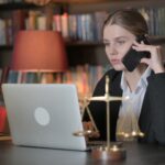 Female,Lawyer,Talking,On,Phone,With,Client, discussing how much does a deposition cost