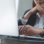 professional woman sitting in front of lap top how to skip trace