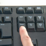 photo showing a finger on the delete button representing deleting of evidence and adverse inference meaning.