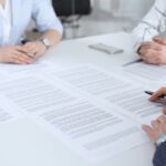 Attorneys in a metting discussing with clients about what happens after a deposition