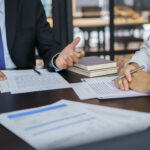Lawyer Legal counsel presents to the client a signed contract.