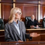 Blonde,Advocate,Pointing,With,Hand,While,Talking,In,Court,Near