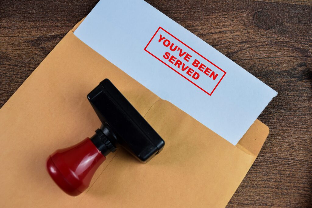 Papers that have been stamped with the words you've been served.